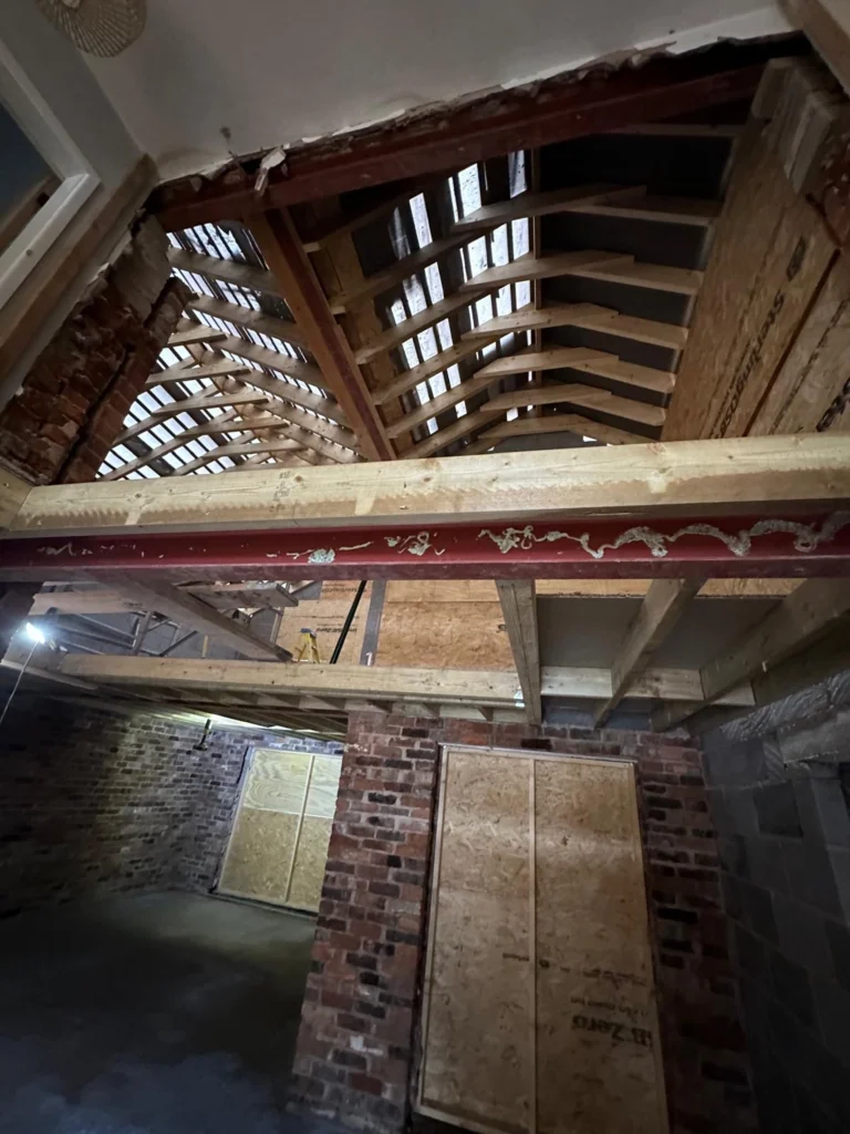 Exposed roof structure, steel beams and brickwork during renovation